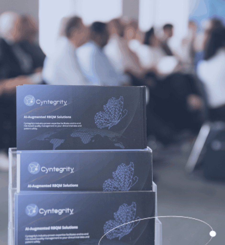 Cyntegrity portfolio-grade RBQM solution brochures displayed at a professional clinical trials event.