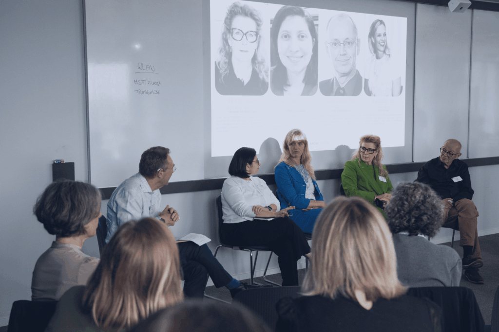 Panel of industry experts participating in an expert dialogue session, seated in discussion during a live event.